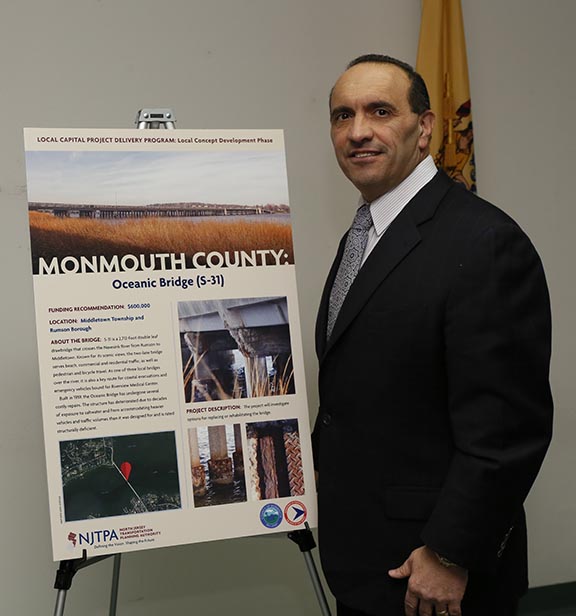 Monmouth County Freeholder and North Jersey Transportation Planning Authority (NJTPA) Board of Trustees member Thomas A. Arnone is pictured with the Oceanic Bridge project summary poster.  The NJTPA Board approved $600,000 in federal funding to perform a Concept Development Study for the replacement or rehabilitation of the Oceanic Bridge in Rumson and Middletown.